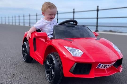 Archie, age 7 months, cruising along the seafront in his hot ride!