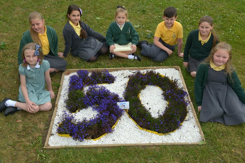 Fens Primary School garden group members (left to right) Jessica Espy, Abbie Ward, Lilli Javenback, Maddie Hillyer, Josh Tucker, Sofie Foster and Jessica Curtains around the 50th Year flower bed.  Remember this from 6 years ago?