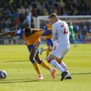 Walsall skipper Peter Clarke tries to slow down Mansfield's Lucas Akins by foul means on Saturday. Photo by Chris Holloway/The Bigger Picture.media