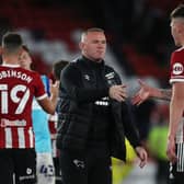 Wayne Rooney, manager of Derby County, congratulates Sheffield United's Kacper Lopata following the Carabao Cup match at Bramall Lane earlier this season: Alistair Langham / Sportimage