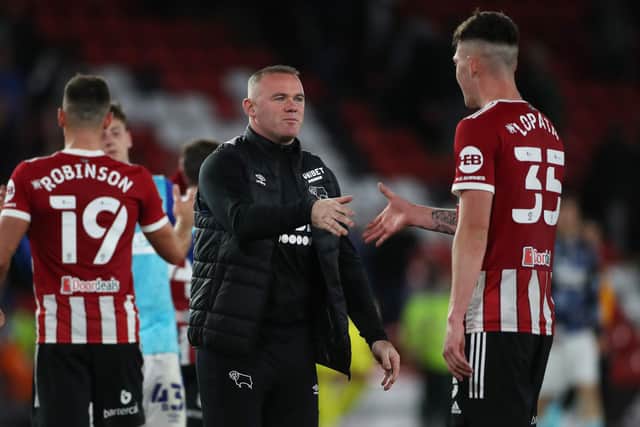 Wayne Rooney, manager of Derby County, congratulates Sheffield United's Kacper Lopata following the Carabao Cup match at Bramall Lane earlier this season: Alistair Langham / Sportimage