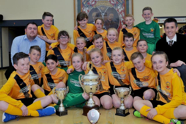 Easington Primary School boy and girl football teams and teachers Michael Shaw (left) and Gary Adey with the trophies they won in 2016. Were you a part of that all-conquering line-up?
