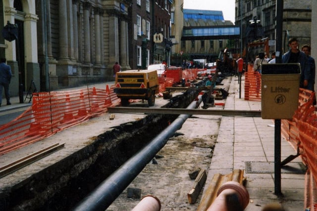 Pipe laying on Norfolk Street, looking towards Surrey Street, as part of the installation of a new heating system to Sheffield Town Hall, converting power from refuse disposal
