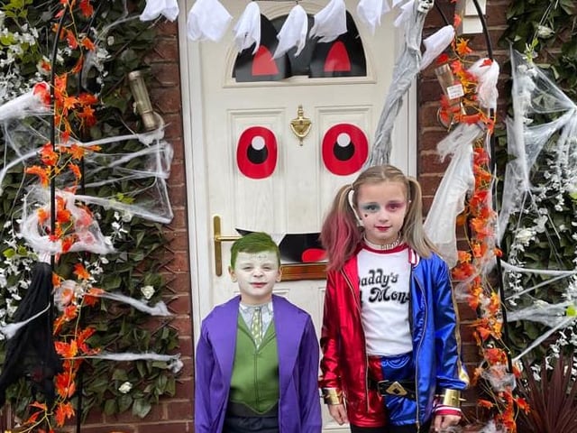 Helen Ruth said: "My joker 7 & Harley Quinn 10 by our Halloween front door."