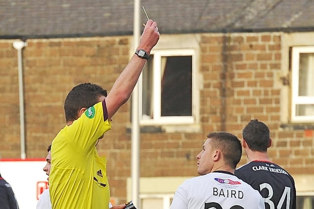 John Baird gets a yellow card from Ref Euan Anderson for protesting the linesman