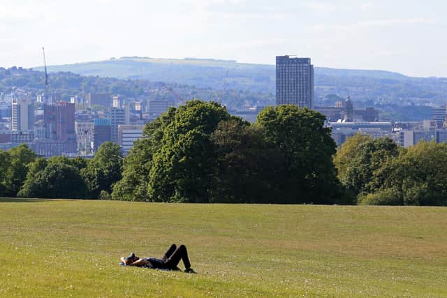 A man lays on the grass to enjoy the sunshine in Norton Park following an easing of lockdown guidelines (Photo by Lindsey Parnaby / AFP) (Photo by LINDSEY PARNABY/AFP via Getty Images)
