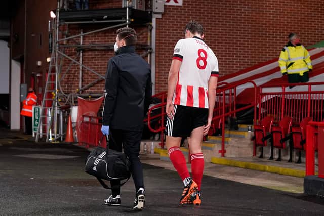 Sander Berge goes off injured during Sheffield United's game against Manchester United: Andrew Yates/Sportimage