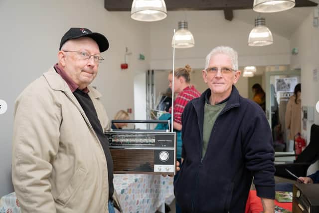 Melvyn Dalley, left, and Ian Moor, with a radio they fixed. Photo Credit Skywall Photography (Dustin Smith)