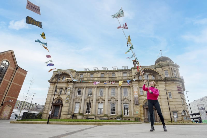 Dina's art programmer Evelyn Albrow unfurls part of ab art installation that was erected in Fitzalan Square