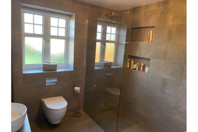 This thoroughly modern bathroom features a walk-in shower.