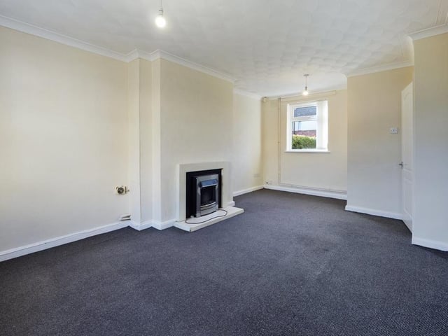 Lounge - Double aspect room with two uPVC double glazed windows, ceiling coving, electric fire unit, T.V point, radiator panel and power points.