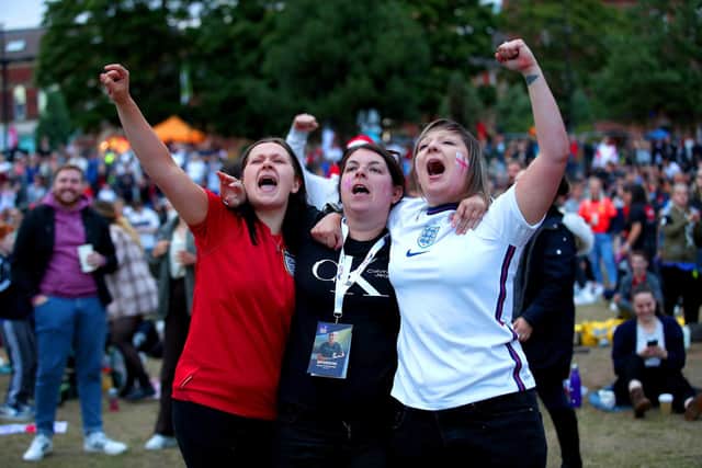 England fans at Devonshire Green celebrate as they watch a screening of the UEFA Women's Euro 2022 semi-final match between England and Sweden held at Bramall Lane, Sheffield. Picture date: Tuesday July 26, 2022. PA Photo. See PA story SOCCER Euro 2022 England. Photo credit: Isaac Parkin/PA Wire.