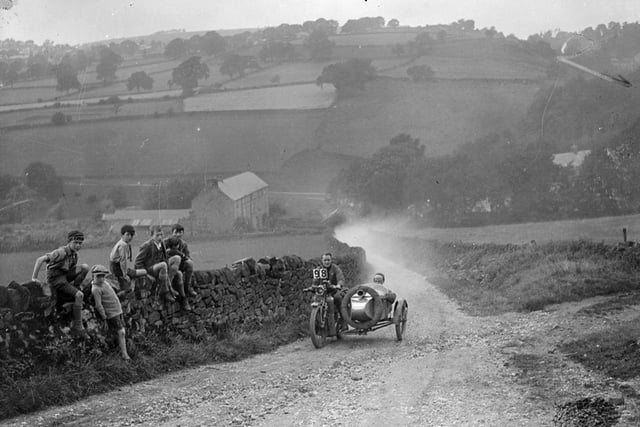 A motorbike rider and sidecar on a rough country lane in the International Reliability Trials in Derbyshire being watched by a group of boys in August 1926:  
 (Photo by Fox Photos/Getty Images)