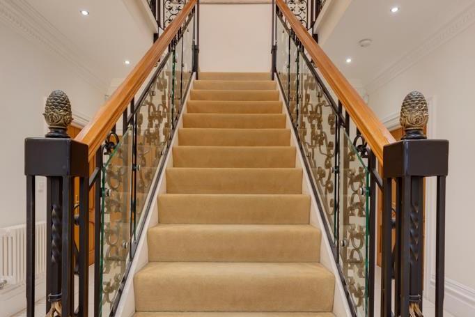 From the entrance hall, a grand staircase with ornate wrought iron balustrading and glazing over and oak hand rails rises to the galleried landing.
