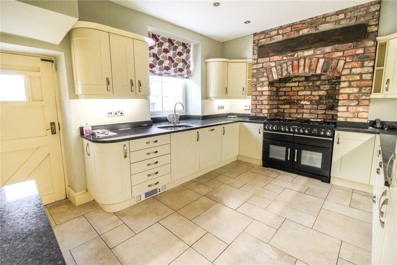 There is an impressive brick chimney breast with beamed lintel over housing the Rangemaster cooker.