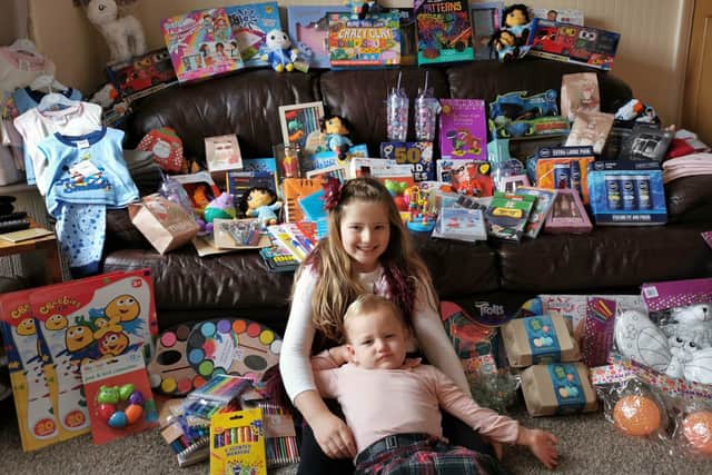 Lainie-Mae Madeley, six, and her one-year-old sister Florence hand made Christmas cards to raise money to buy presents for a Salvation Army appeal