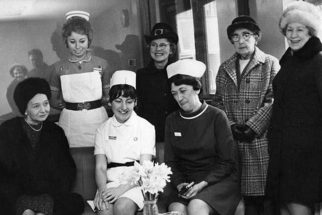 Representatives of the Concordia Club present furnishings for the waiting room of the children's ward at the Ingham Infirmary in 1974.