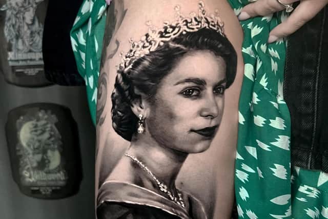 Amazing portrait of the late Queen Elizabeth II tattooed on the right thigh of Falon Cooper. See SWNS story SWSMtatto; A woman has had an amazing remembrance portrait of 'our most treasured' Queen Elizabeth II tattooed on her leg. 
