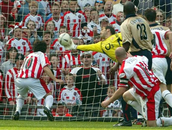 David Seaman stretches to deny Paul Peschisolido at Old Trafford.