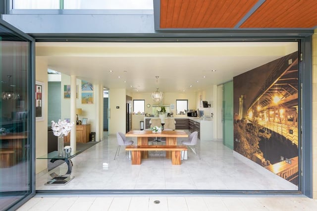 The dining area of the open-plan space is also accompanied by large bi-folding doors which are located across the entirety of the back of the property.