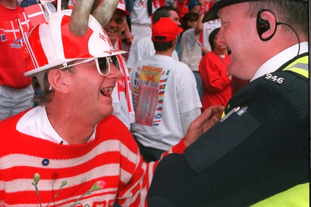 This Danish Fan enjoys a Farewell joke with a South Yorkshire Police Officer after Denmarks last game at Hillsborough in Euro 96.