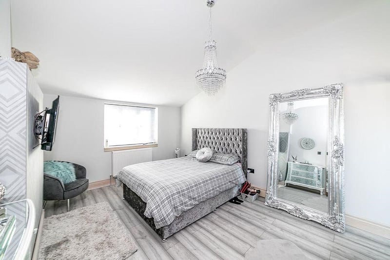 The master bedroom includes fitted wardrobes and a stylish ensuite shower room.