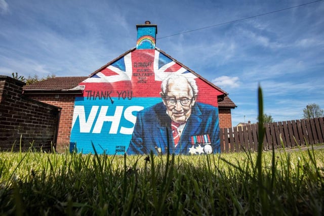 A street art graffiti mural, showing the logo of the NHS and an image 100-year-old veteran Colonel Tom Moore in east Belfast on May 5, 2020. (Photo by Paul Faith / AFP)