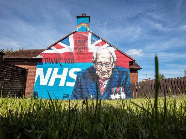 A street art graffiti mural, showing the logo of the NHS and an image 100-year-old veteran Colonel Tom Moore in east Belfast on May 5, 2020. (Photo by Paul Faith / AFP)