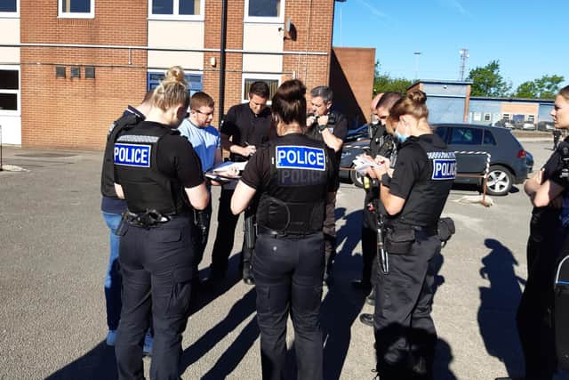 A team of officers being briefed before this morning's raids