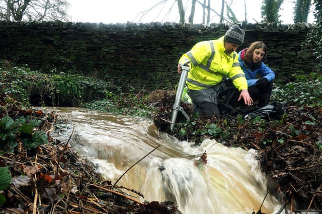 Sheffield and Rotherham Wildlife Working with Water project: Dr Jon Bridge and student Becky Dennison checking a water flow monitor near Agden reservoir