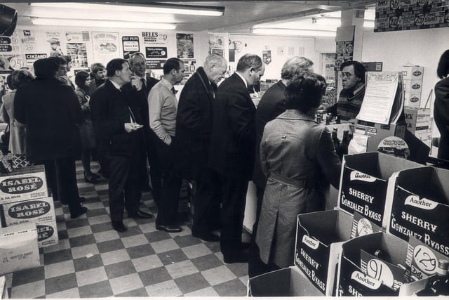 Beat the budget drinkers were out in force as this crowd formed at Augustus Barnett Wines and Spirits on Ecclesall Road South in April 1975