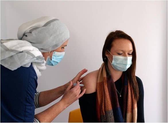 A nurse administers a covid vaccination.
