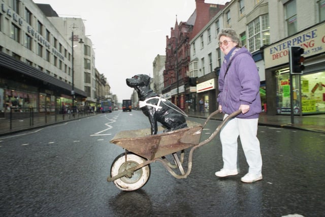 Hobo the black labrador charity dog that stood inside Binns store for 15 years collecting hundreds of pounds for Sunderland and South Shields Guide Dogs Association finds himself outside the store and homeless. He is pictured with owner Jennifer Emerson in 1993.
