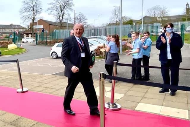 The red carpet treatment as Mr Farrell arrives at school for the last time.