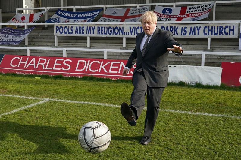 Britain's Prime Minister Boris Johnson practices his skills during a visit to Hartlepool United Football Club as he campaigns on behalf of Conservative Party candidate Jill Mortimer in Hartlepool, north-east England on April 23, 2021, ahead of the 2021 Hartlepool by-election to be held on May 6.