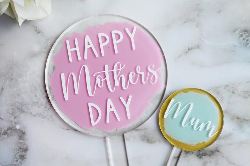 Nicola Chessum has created a clever seven-inch edible icing topper, as well as two acrylic paddles (pictured), which can be handmade to order with 'mum' slogans.