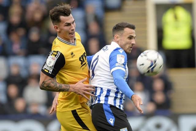 Sheffield Wednesday forward Lee Gregory jumps for a ball against Lincoln City.