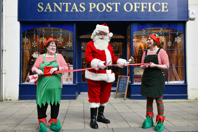 Two of Santa's elves helped him officially open his post office on the High Street at the weekend.