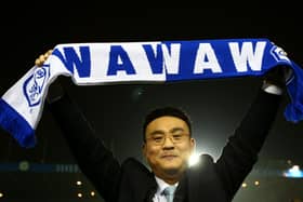 Sheffield Wednesday owner Dejphon Chansiri holds aloft a club scarf. The Owls are facing several weeks before any matchday revenue is due.