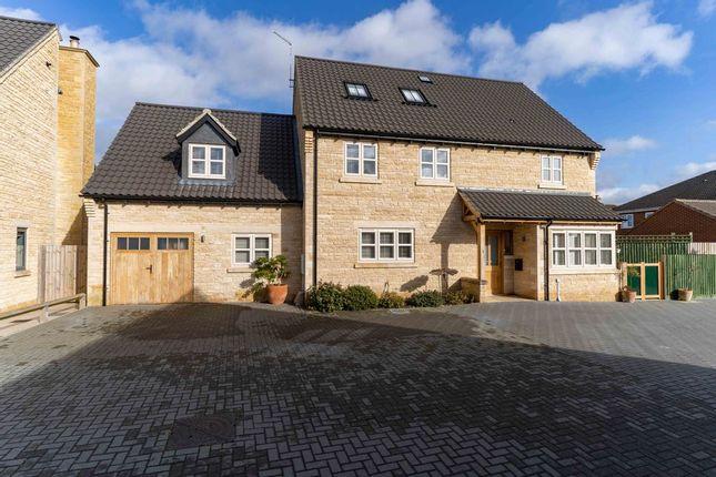 This pretty property is built in Clipsham Gold natural stone, with grey roof tiles and finished with cream uPVC windows