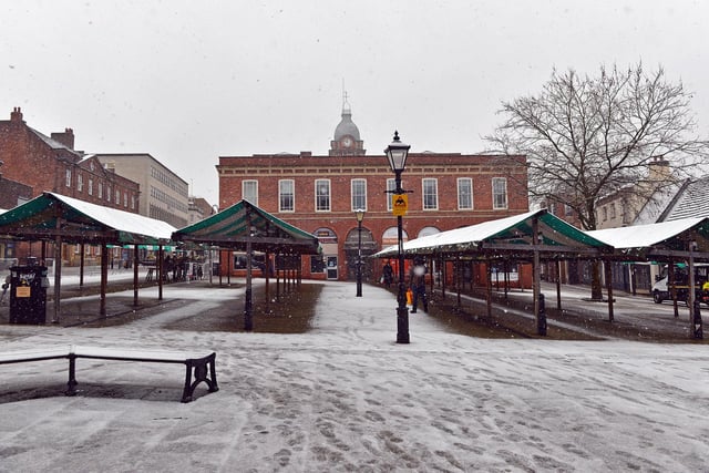 Empty market stalls looking pretty in the snow in Chesterfield