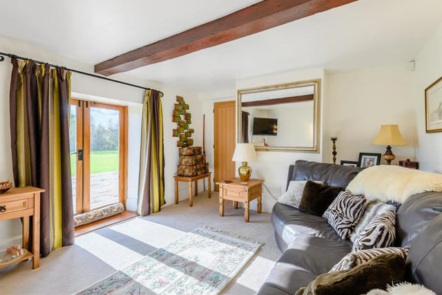 The snug at Warsop Cottage Farm is a cosy reception room. It has a central beamed ceiling and French doors leading on to the substantial patio outside.