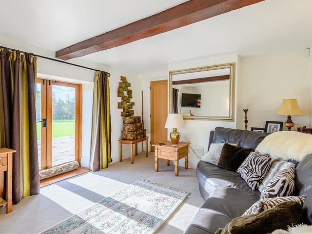 The snug at Warsop Cottage Farm is a cosy reception room. It has a central beamed ceiling and French doors leading on to the substantial patio outside.