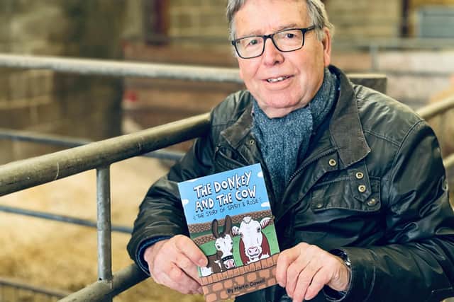 Martin Cowell, with his book: The Donkey and the Cow, which he's selling at Whirlow Hall Farm this Christmas