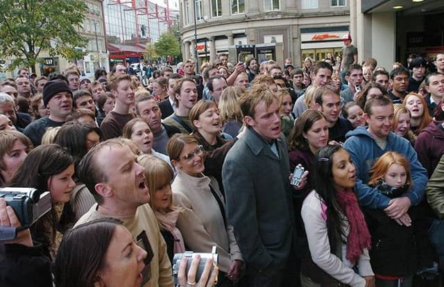 Fans gather to see Travis perform outside Virgin on Fargate in Sheffield, on Monday, October 11, 2004