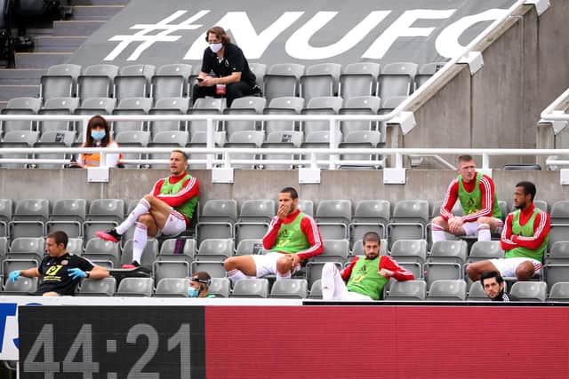 Subtitute players of Sheffield United are sat with distance during the Premier League match between Newcastle United and Sheffield United at St. James Park . (Photo by Laurence Griffiths/Getty Images)
