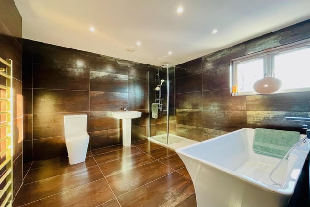 The contemporary finish to this en-suite bathroom fits perfectly with such a stylish property.