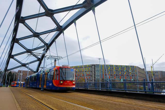 A Supertram crosses the Commercial Street Bridge with the iconic Park Hill flats in the background on its way in to the city centre
