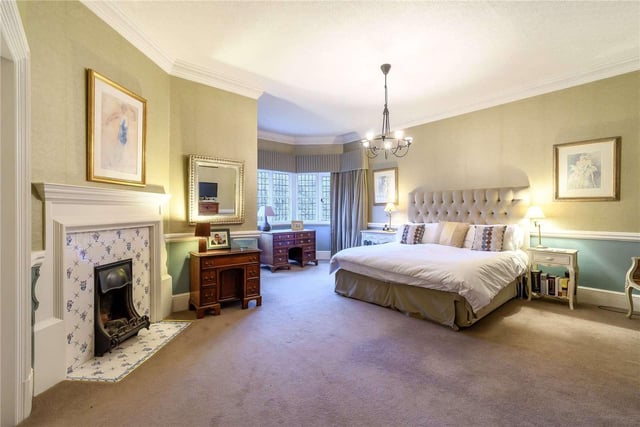 The master bedroom overlooks the gardens and includes an original fireplace, an en-suite bathroom and a walk-in wardrobe.
