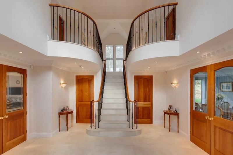 Having side-facing double-glazed windows, full height vaulted ceiling, wall mounted light points, decorative coving and honed marble tiled flooring. An imperial staircase with wrought iron spindles and cherry wood balustrading rises to the half-landing and first floor.